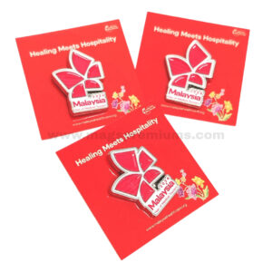 Metal enamel lapel pins displayed on red backing cards