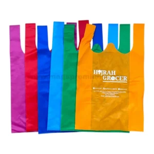 Custom singlet non woven bag with Hijrah Grocer logo printed on orange reusable shopping bag