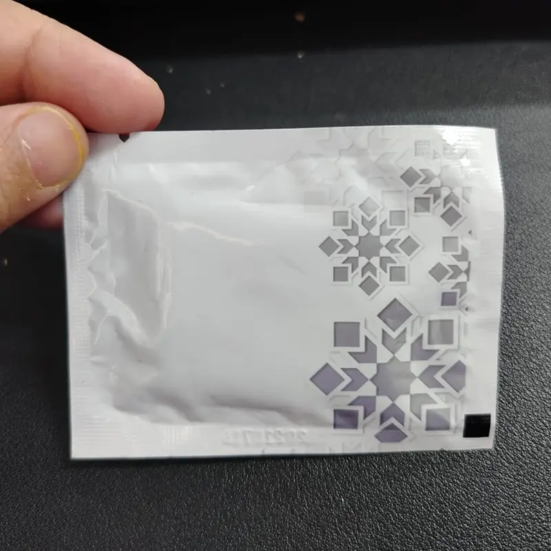 Wet Wipes Printing custom printed wet tissue sachet with geometric design packaging held in hand