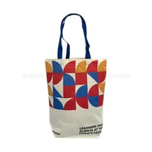 Custom printed canvas tote bag with colorful geometric pattern and blue handles for promotional giveaways and corporate branding