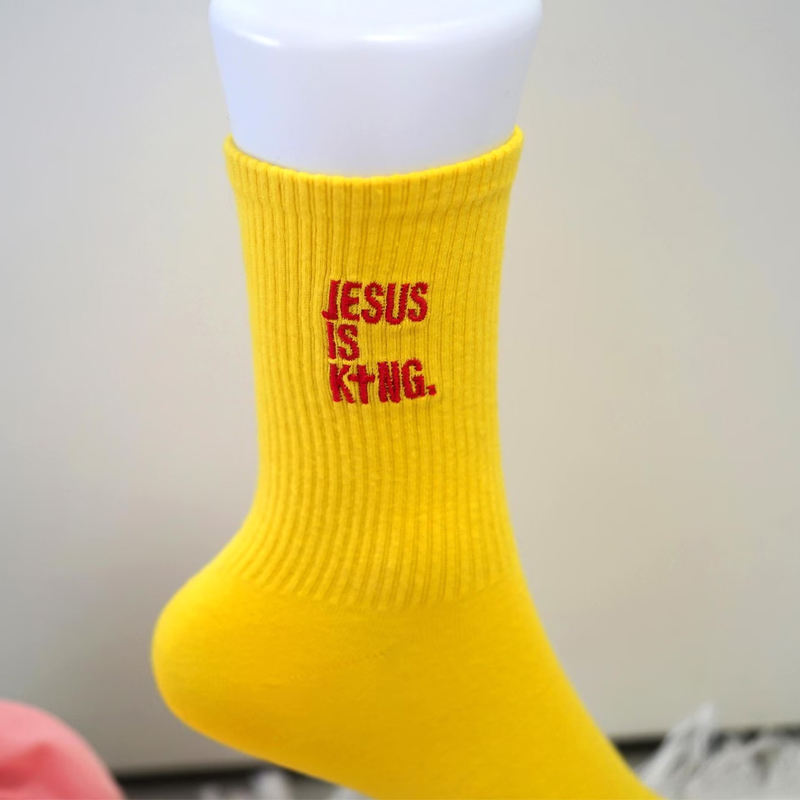 Custom Embroidery Socks Yellow custom crew socks with embroidered slogan design for branded apparel and merchandise