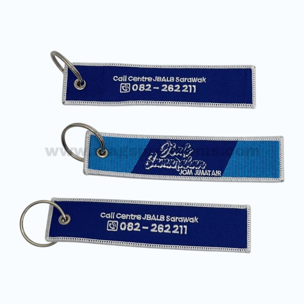 Embroidered Keychains embroidered fabric keychain with woven text and metal key ring.