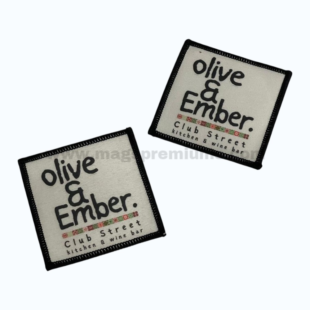 Sublimation Patches custom woven label patch with merrow border for branding and garment applications.