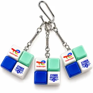Custom clicker keychain with four keyboard switch keycaps printed with the TotalEnergies logo and a Cyber Security design, with metal snake chain and clip